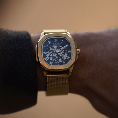 Thomas & George Berlin Gold Edition Automatic Skeleton Watch | Cushion-Shaped Gold-Tone Alloy Case & Roman Numeral Dial | Stainless Steel Mesh Strap